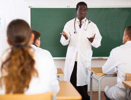 Professor talking to medical students in classroomの写真素材