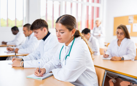 Young girl medical intern listening to lecture at universityの写真素材