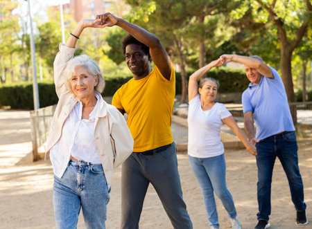 Elderly woman enjoying dance with partner in gardenの写真素材