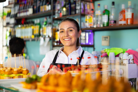Female bartender offering delectable sandwiches pinchos in bar