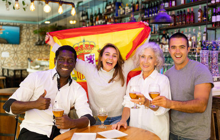 Happy fans celebrating the victory of Spanish team in barの写真素材