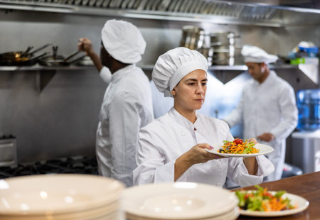 Portrait of woman chef giving out meal