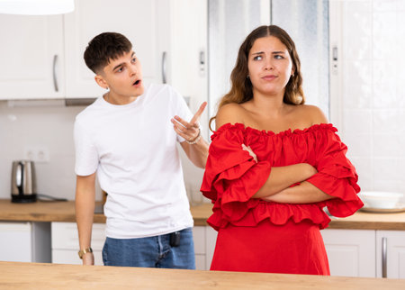 Young husband is dissatisfied with the act of his wifeの写真素材