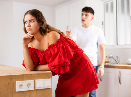 Domestic quarrel of a young family in kitchenの写真素材