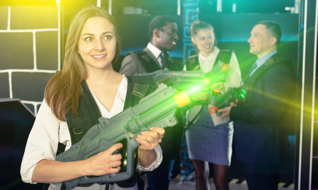 Woman holding laser gun and playing laser tagの写真素材