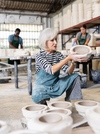 Positive woman potter with mould for new wareの写真素材