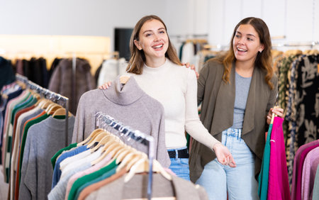 Two women shopping warm clothes in storeの写真素材