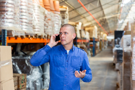 Storekeeper having telephone conversation during working dayの写真素材