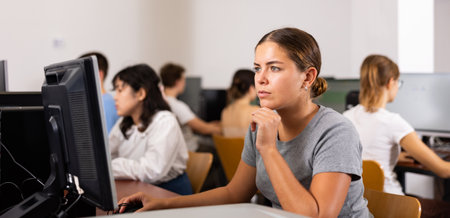Young woman using computer in classroomの写真素材