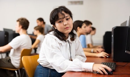 Teenage girl using computer during lessonの写真素材