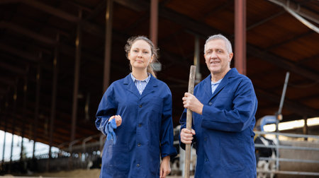 Portrait of man and woman positive cow farm workers