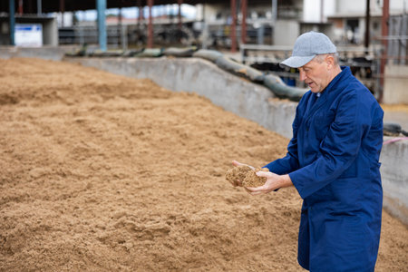 Male farmer with bunch of soy husks in his hands