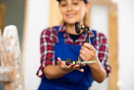 Blurred woman builder holding door handleの写真素材