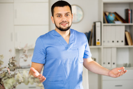 Portrait of positive man physician explaining with gesturesの写真素材