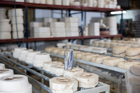 Gypsum molds for casting ceramic utensils in workshop of pottery factoryの写真素材