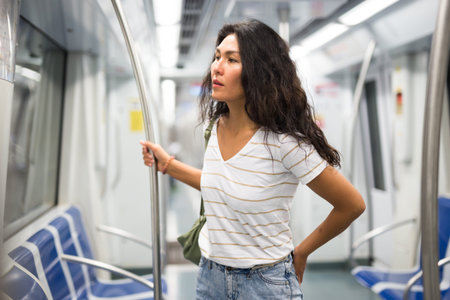 Woman standing in subway train