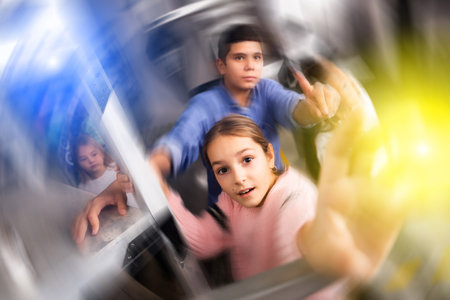 Tween children trying to solve riddles in quest room, toned imageの写真素材