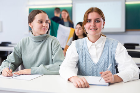 Teacher stands behind students with flag of Irelandの写真素材