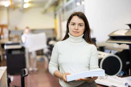 Portrait of happy woman with a stack of paper in her hands in typography