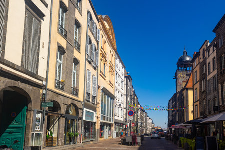 Typical facades built with volcanic stones in the clock tower street of Riom, Franceのeditorial素材