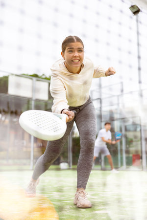 View through tennis net of an female playing padelの写真素材