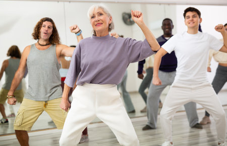 Elderly lady learning modern dynamic dances in choreography classの写真素材