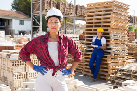 Portrait of female worker at warehouse of building materials in open airの写真素材
