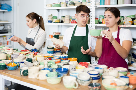 Young man and young woman examining pottery