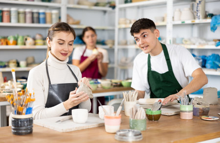 Young woman and young man making potteryの写真素材