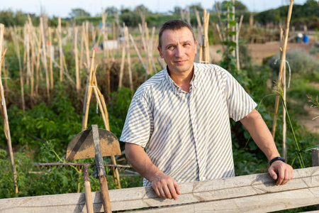 Portrait of positive man at fenceの写真素材