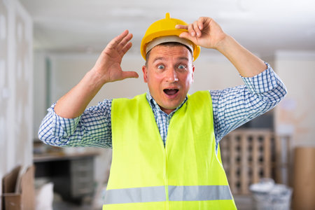 Portrait of surprised man builderの写真素材