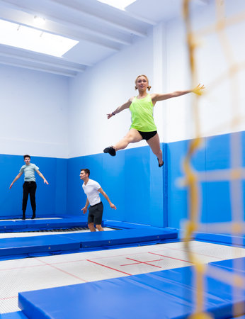 Athletic girl training in trampoline centerの写真素材