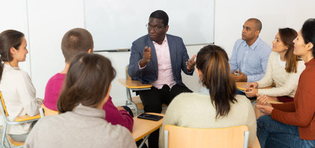 Multicultural people meeting in circle of chairs