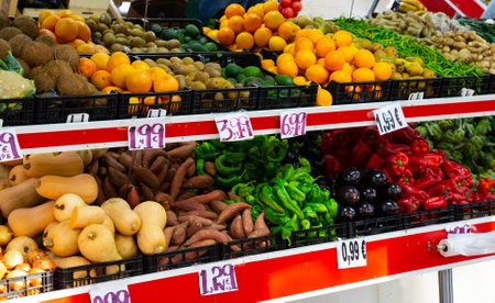 Fruits and vegetables on shelves in supermarketの写真素材