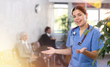 Young female doctor posing in clinic receptionの写真素材
