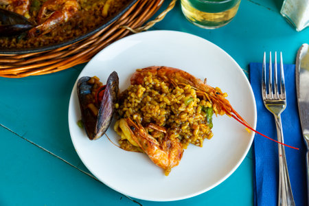 Delicious traditional Valencian seafood paella - savory rice dish with shrimps and clamsの写真素材
