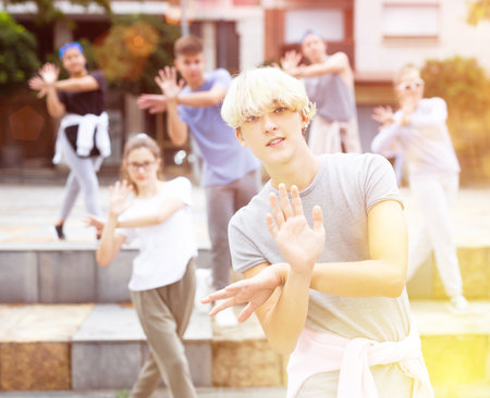 Confident teenager street dancer performing with groupの写真素材