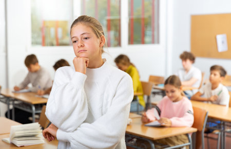 Portrait of thoughtful teenager girl in schoolの写真素材