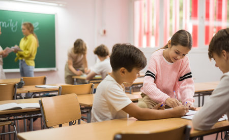 Schoolchilds working in groups at lesson