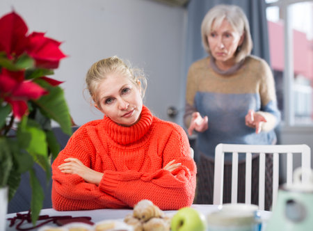 Mature woman quarrels with her adult daughterの写真素材