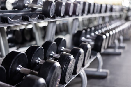 Rows of dumbbells for free weight training on rack in gymの写真素材