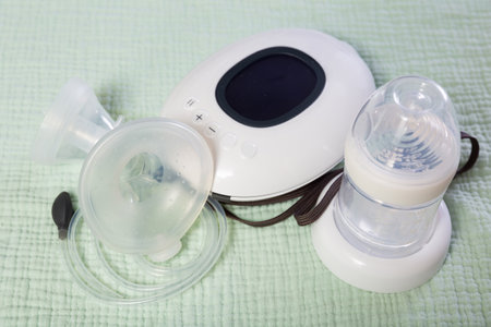 Isolated electric portable breast pump with blank bottle and replaceable nipple for feeding newbornの写真素材