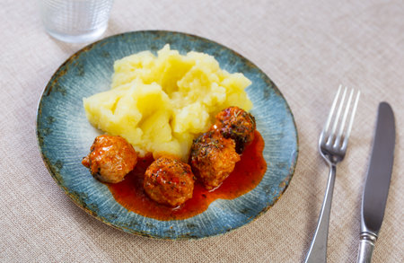 Nice tasty meatballs served with mashed potatoes and gravy on sideの写真素材