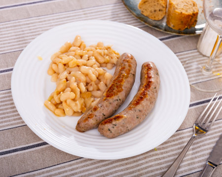 Botifarra amb mongetes, representative dish of Catalan home cooking - traditional fried botifarra sausage served with cooked white beans..の写真素材