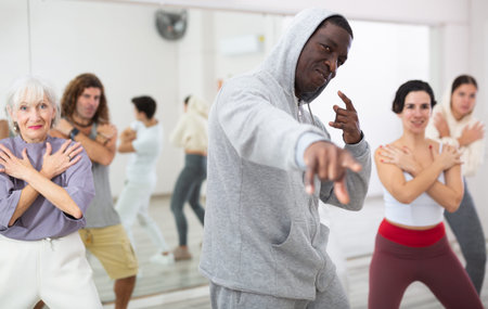 Group of multinational people practicing new modern dance techniques