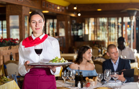 Portrait of waitress ready to serving mealsの写真素材
