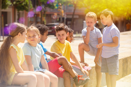 Group of children of different nationalities communicate on a streetの写真素材