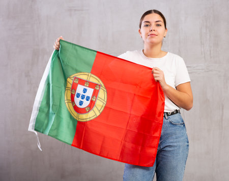 Focused woman holding Portugal flagの写真素材