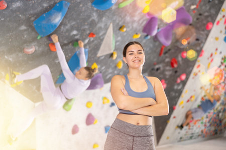 Young woman posing on climbing wallの写真素材