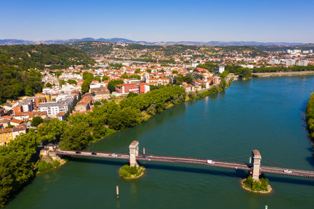 Aerial view of French commune of Givors on Rhone river in summer